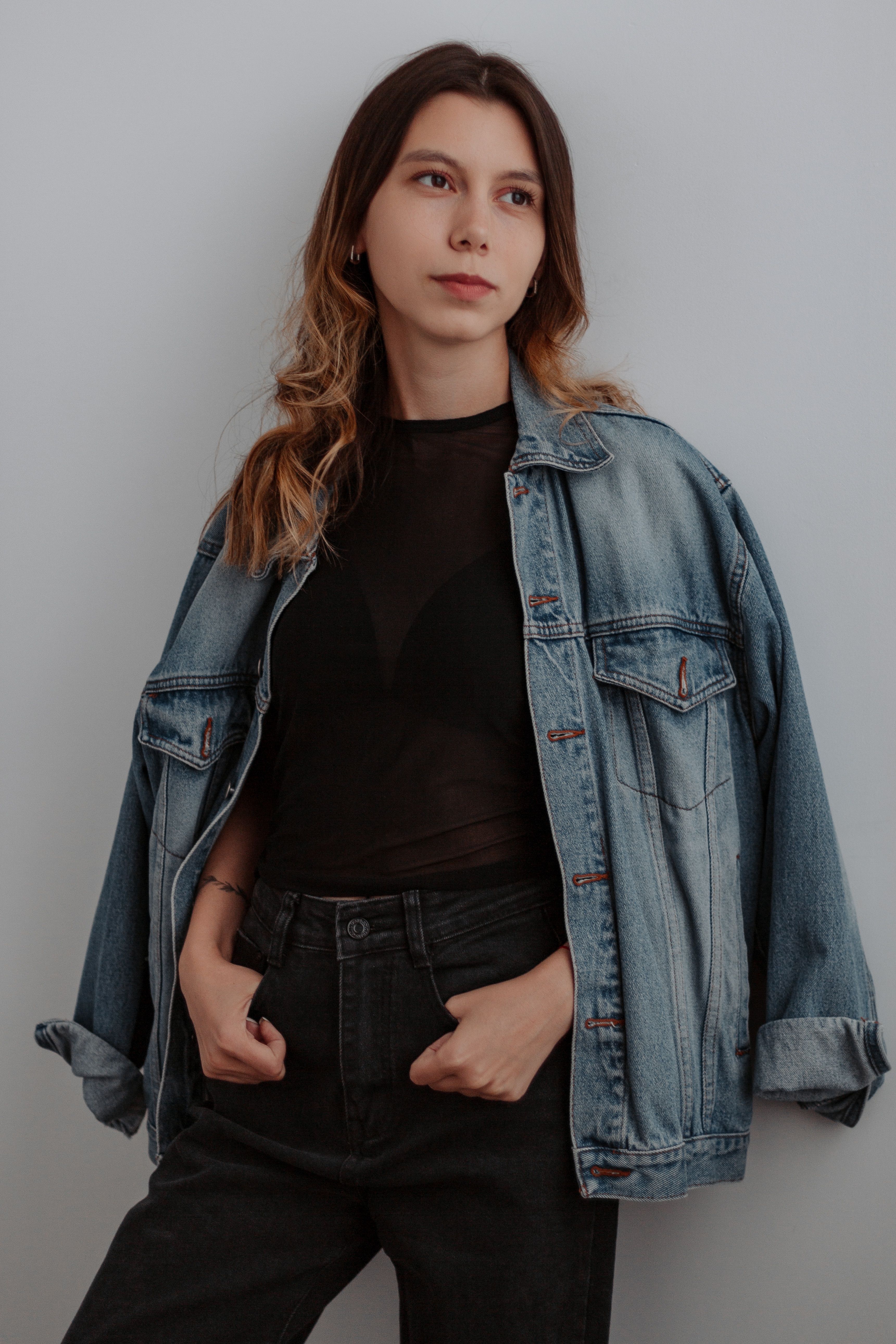Woman in a denim jacket with black trousers