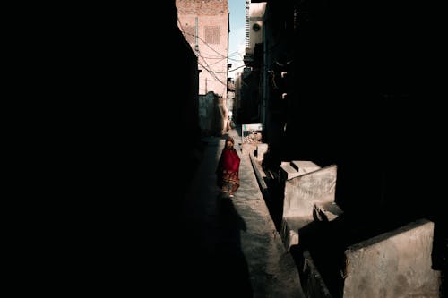 Person Walking Along Dark Alley