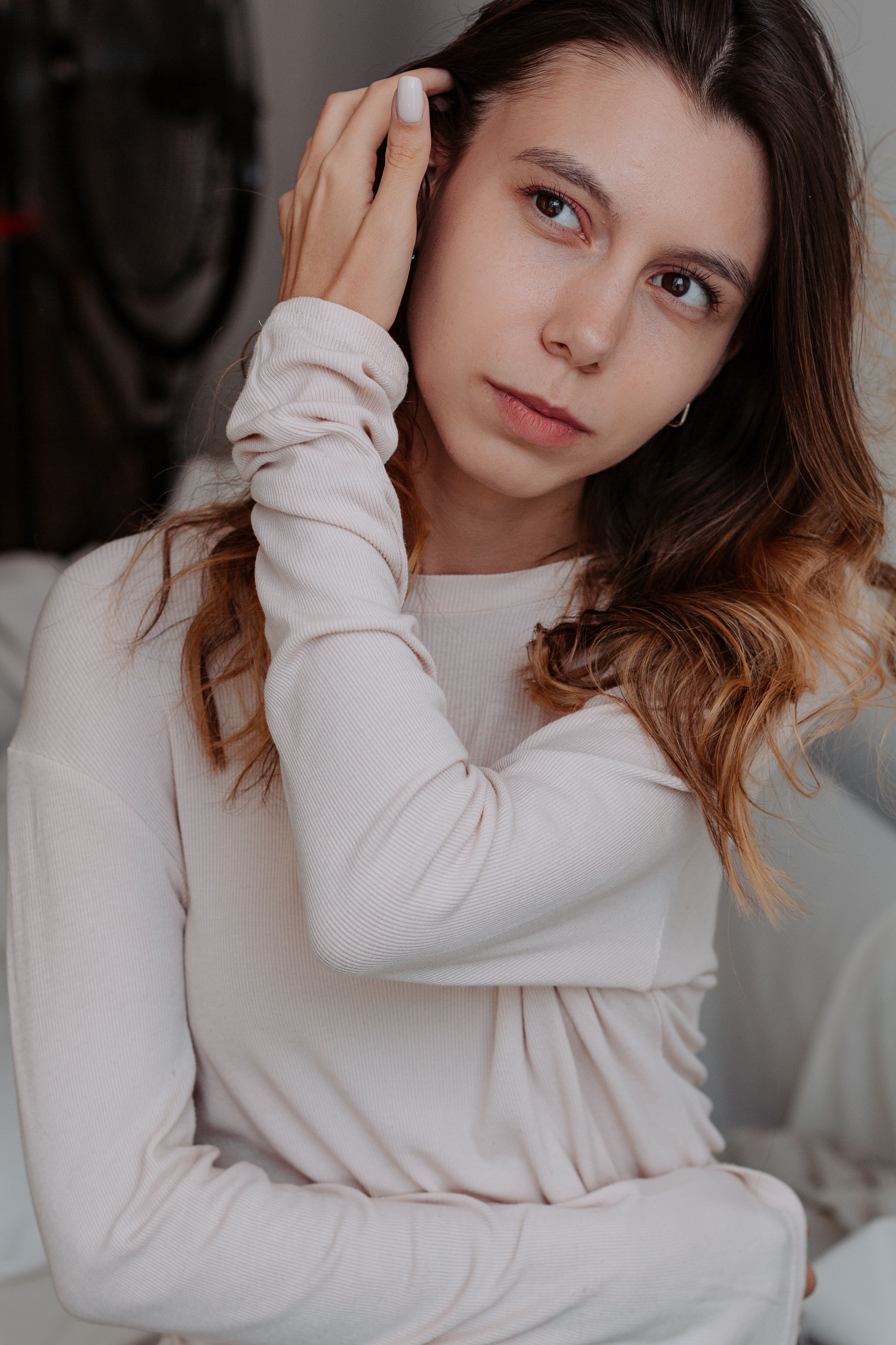 A woman is posing for a photo in a white shirt · Free Stock Photo