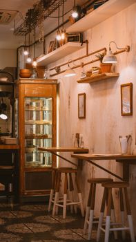 Warm and inviting café interior with vintage decor, wooden furniture, and retro lighting.