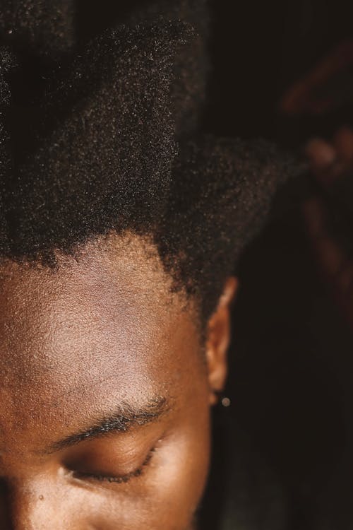 A man with dreadlocks is combing his hair