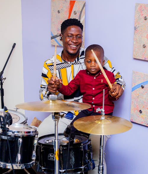 Smiling Father and Son Playing Drums