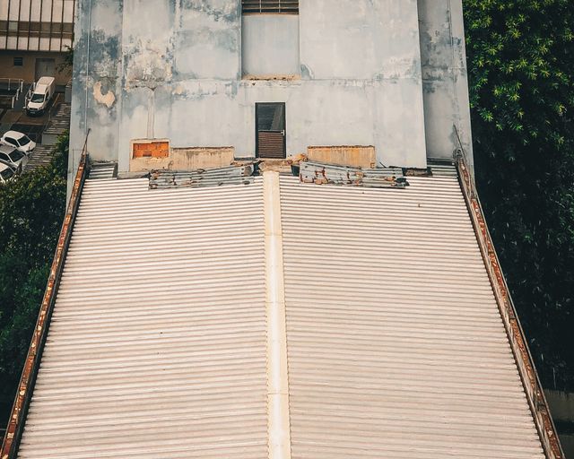 Industrial flat roof from above Aerial view of a weathered industrial roof surrounded by trees