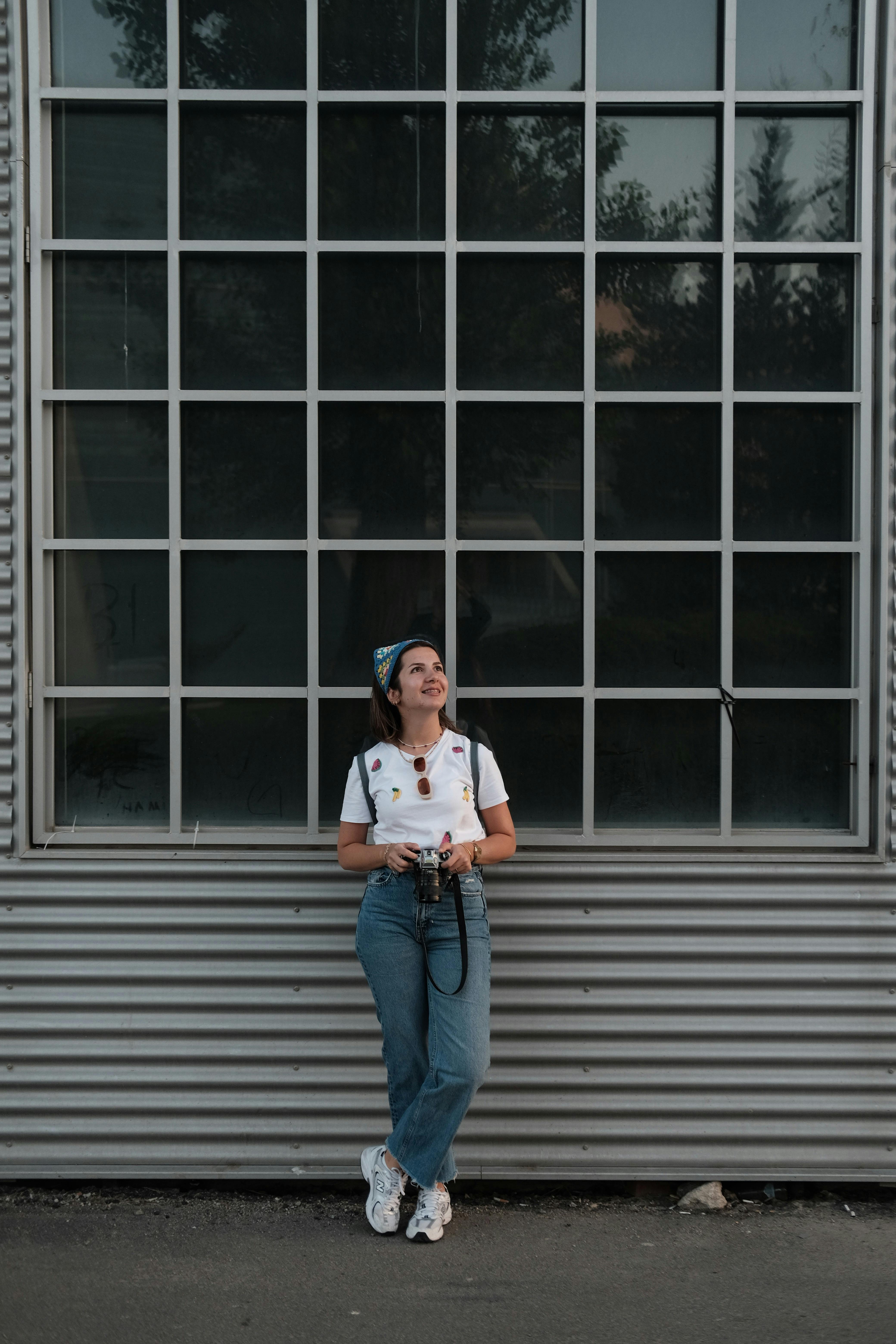 a woman standing in front of a large window