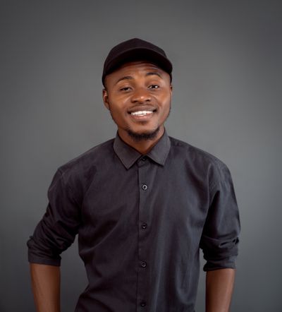 Portrait against a plain wall, photo by Victor Oluwayoju on Pexels