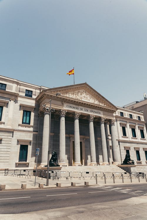 A building with a flag on top and a statue