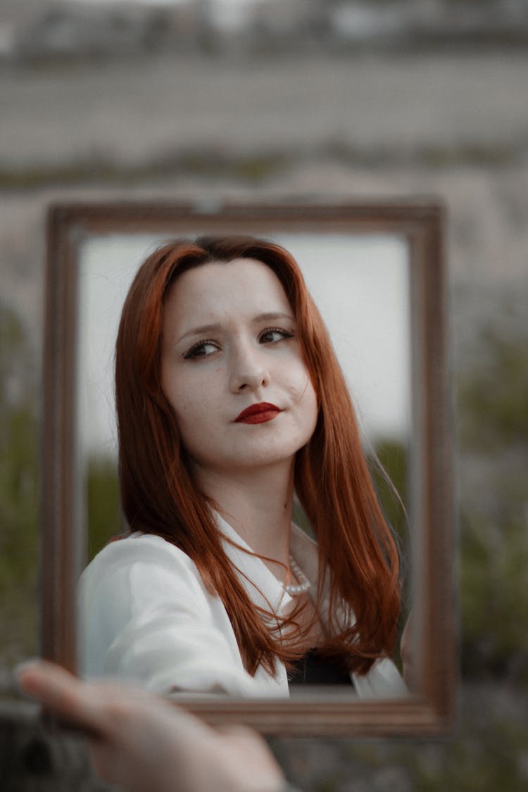 Redhead Woman Reflecting In Mirror