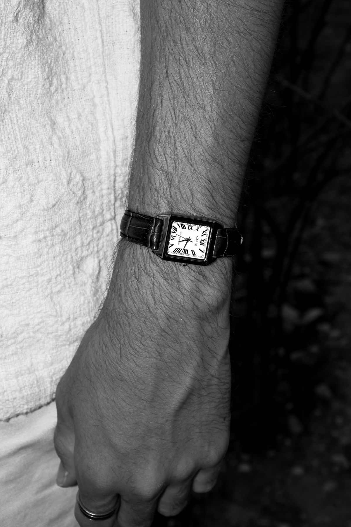 Wristwatch on a leather strap worn on a man's wrist