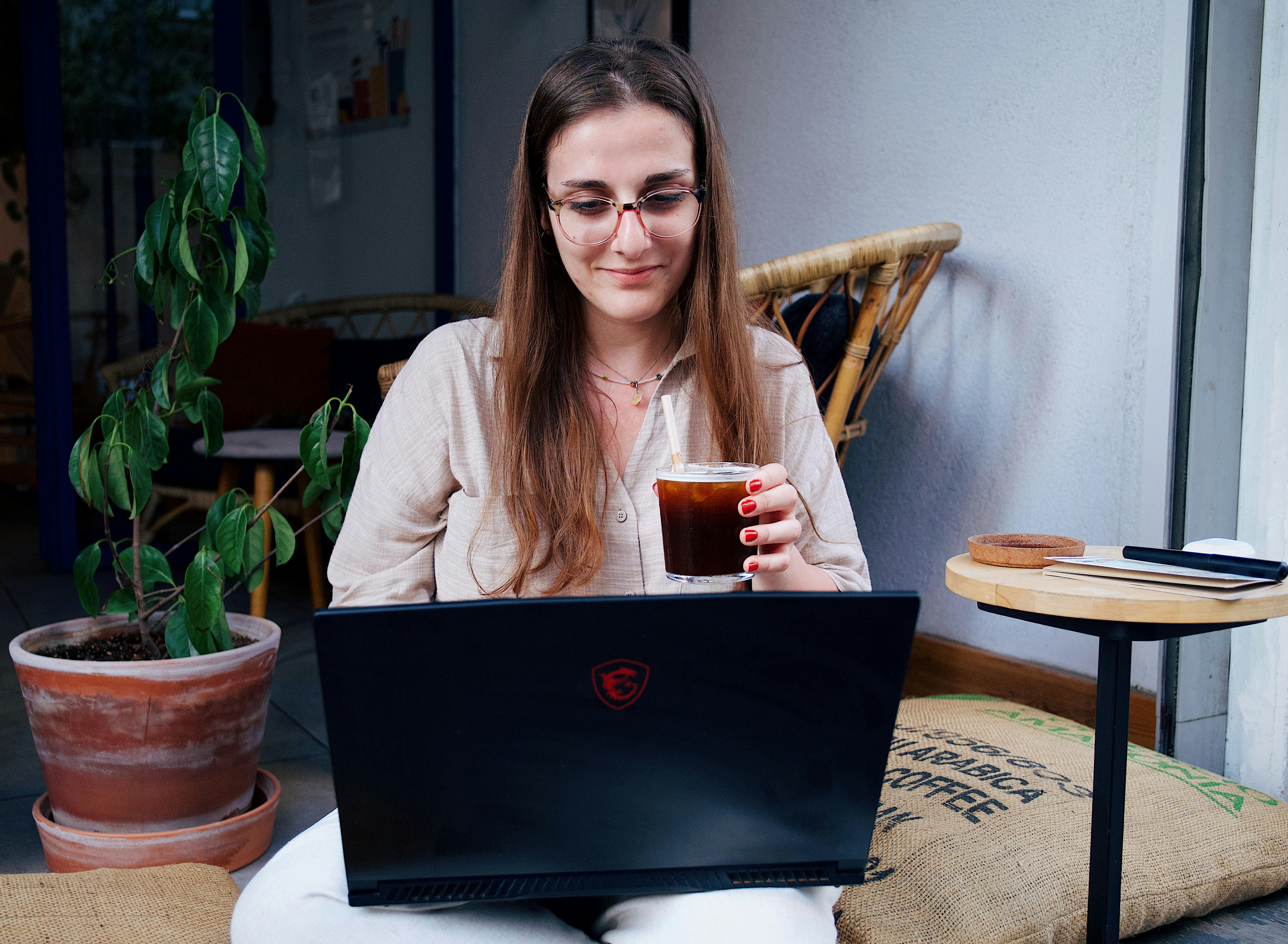 a woman sitting with a laptop