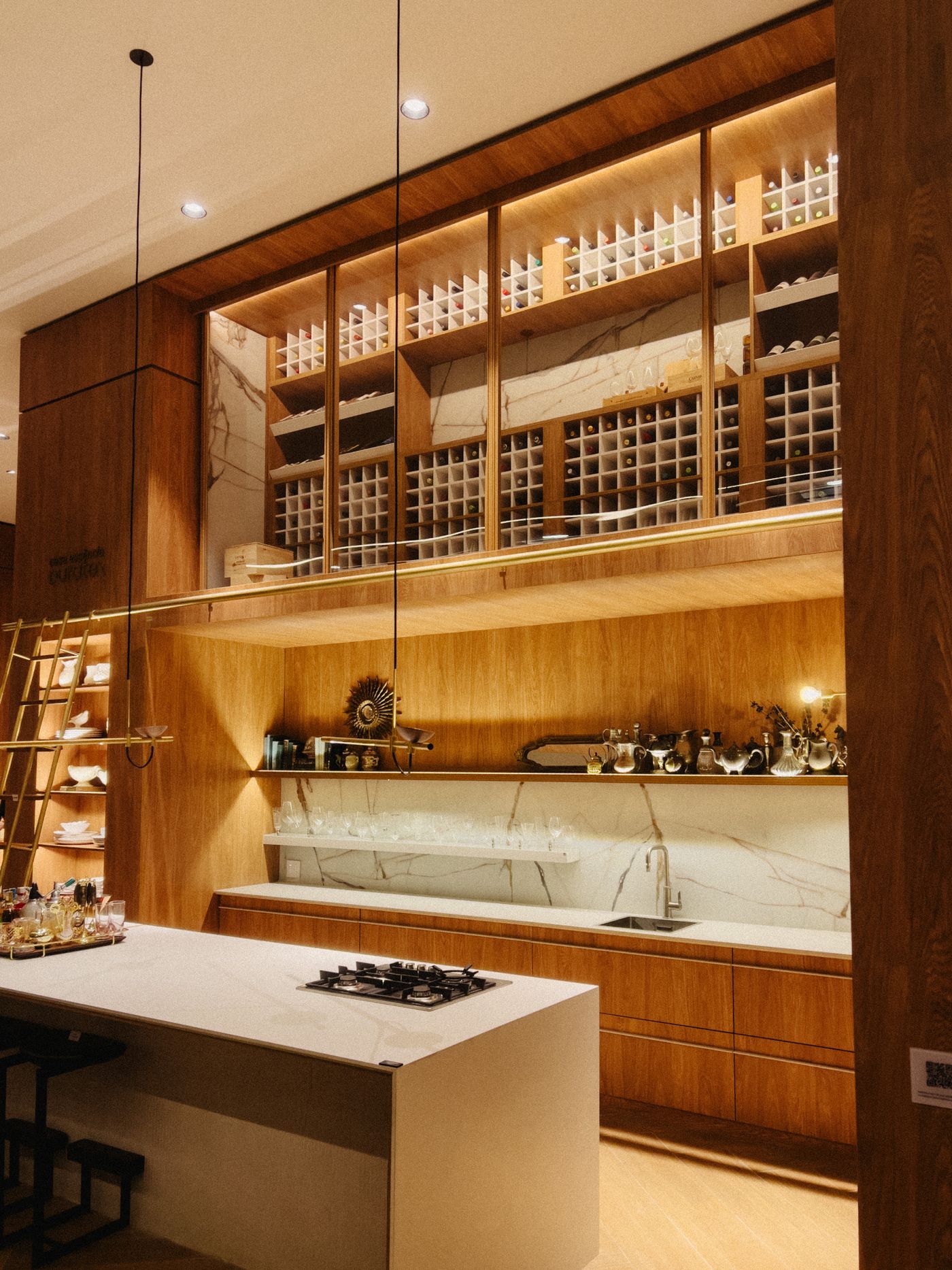 Modern luxury modular kitchen with warm wood cabinetry and integrated lighting