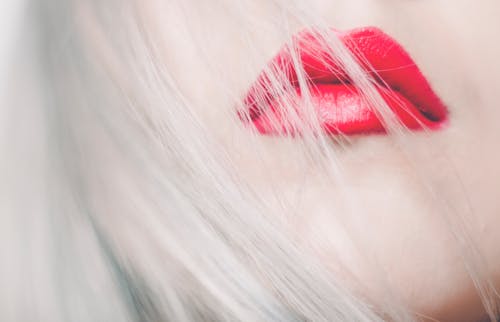 Close-up Photography of Woman Wearing Red Lipstick