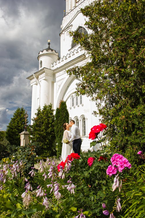 Newlyweds Kissing by Palace Entrance
