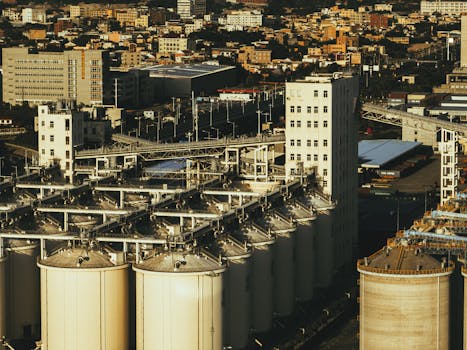 Aerial view of industrial silos with cityscape in Xiamen, China.