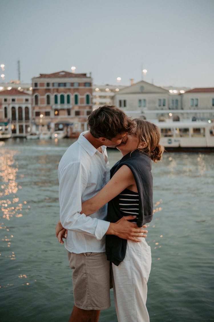 Couple Kissing Near Canal On Sunset