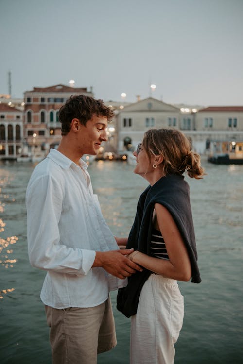 Smiling Couple Hugging near Canal on Sunset