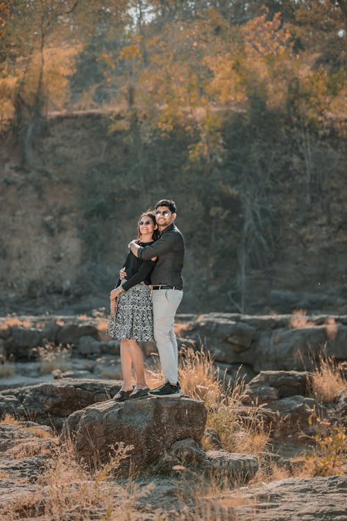 Young Couple Standing on a Stone and Embracing