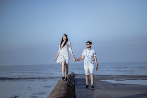 A Couple Holding Hands on a Beach