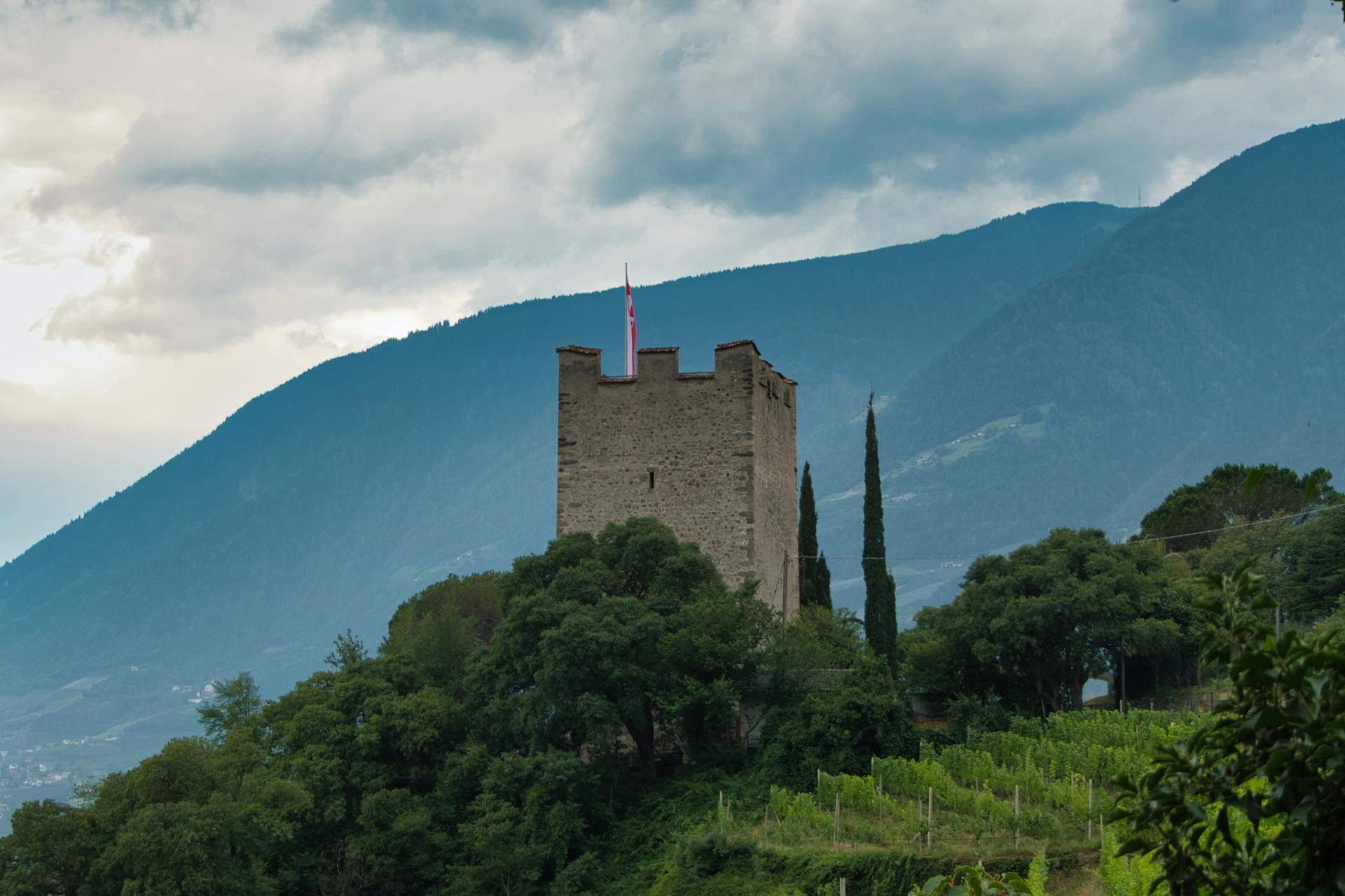 Discover the historic castle nestled in scenic Merano, surrounded by vineyards and mountains.