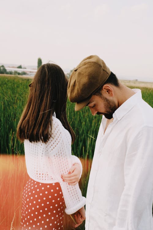 Couple Standing on Green Field