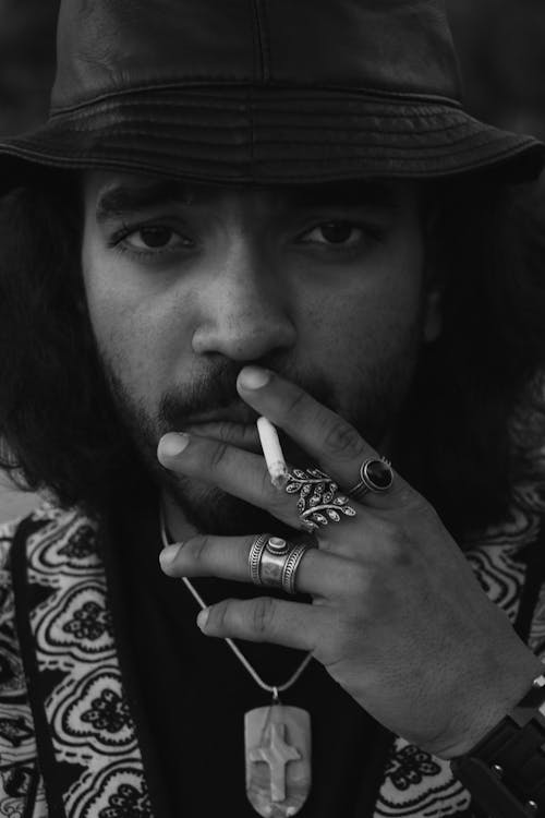 Black and White Portrait of a Man in Hat Smoking a Cigarette 