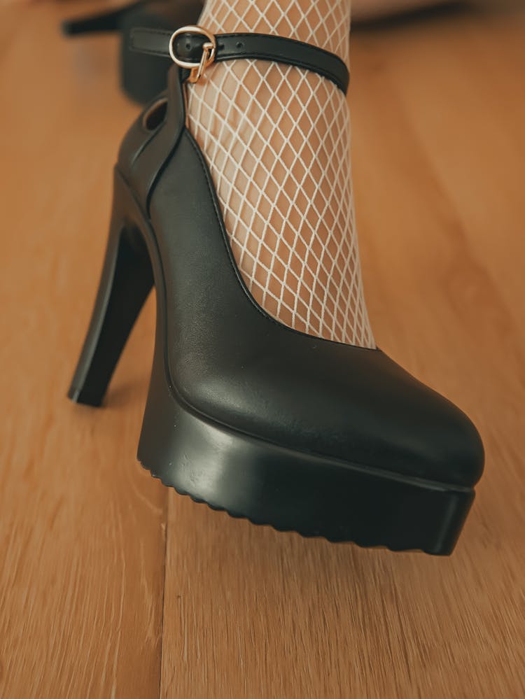 Leg With Fishnet Stocking In Heels