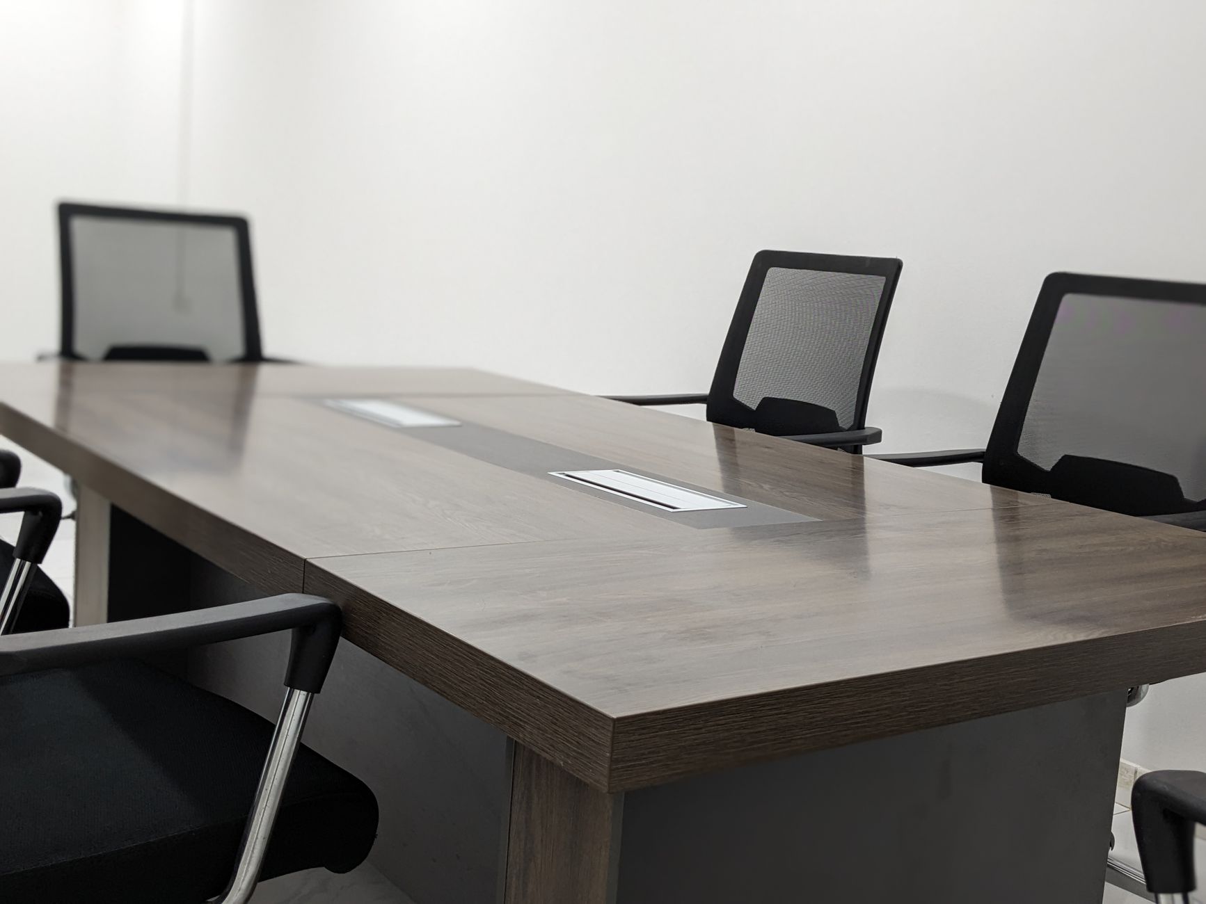 Sleek and empty conference room with modern furniture and minimalist design.