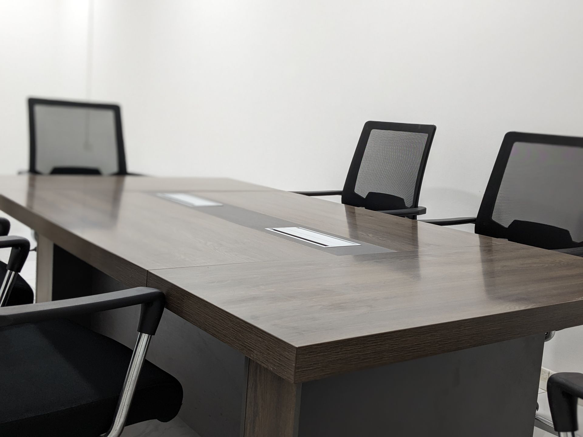 Sleek and empty conference room with modern furniture and minimalist design.