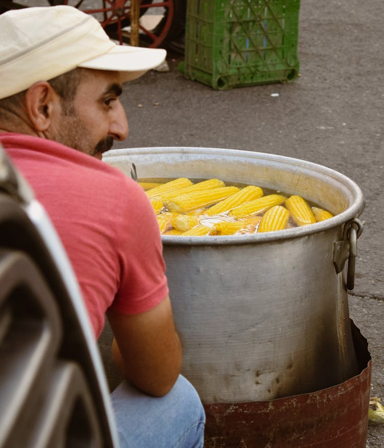 Man Cooking Corn On A Street 