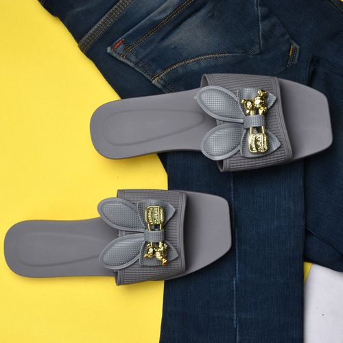 Free Elegant gray sandals with gold accents on denim jeans in a flat lay style, perfect for fashion enthusiasts. Stock Photo