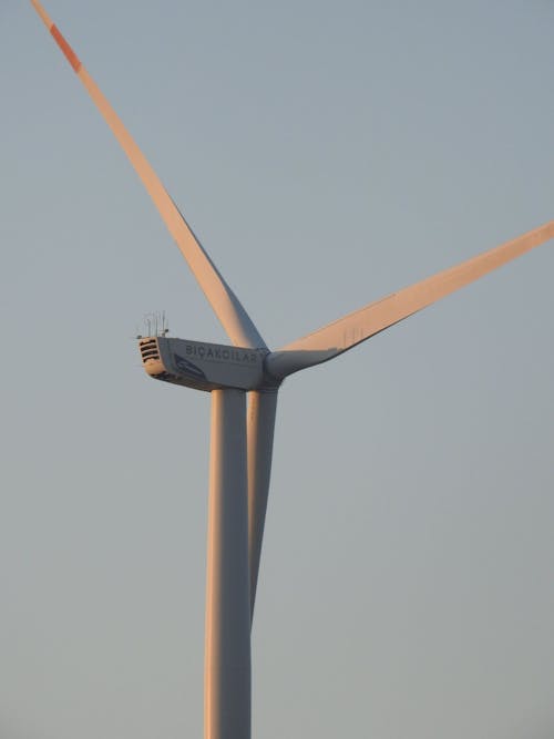 Close-Up Photo of a Wind Turbine against Clear Blue Sky