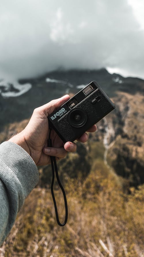 Man Holding an Ilford Analog Photo Camera