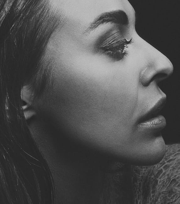 Artistic monochrome profile portrait capturing a woman's intricate facial features and expression.