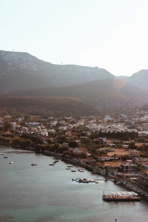 Free Scenic view of İzmir town with tranquil harbor and mountains at sunset. Stock Photo