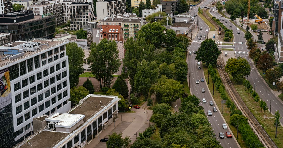 Aerial view of Warsaw city showcasing modern architecture, streets, and greenery.