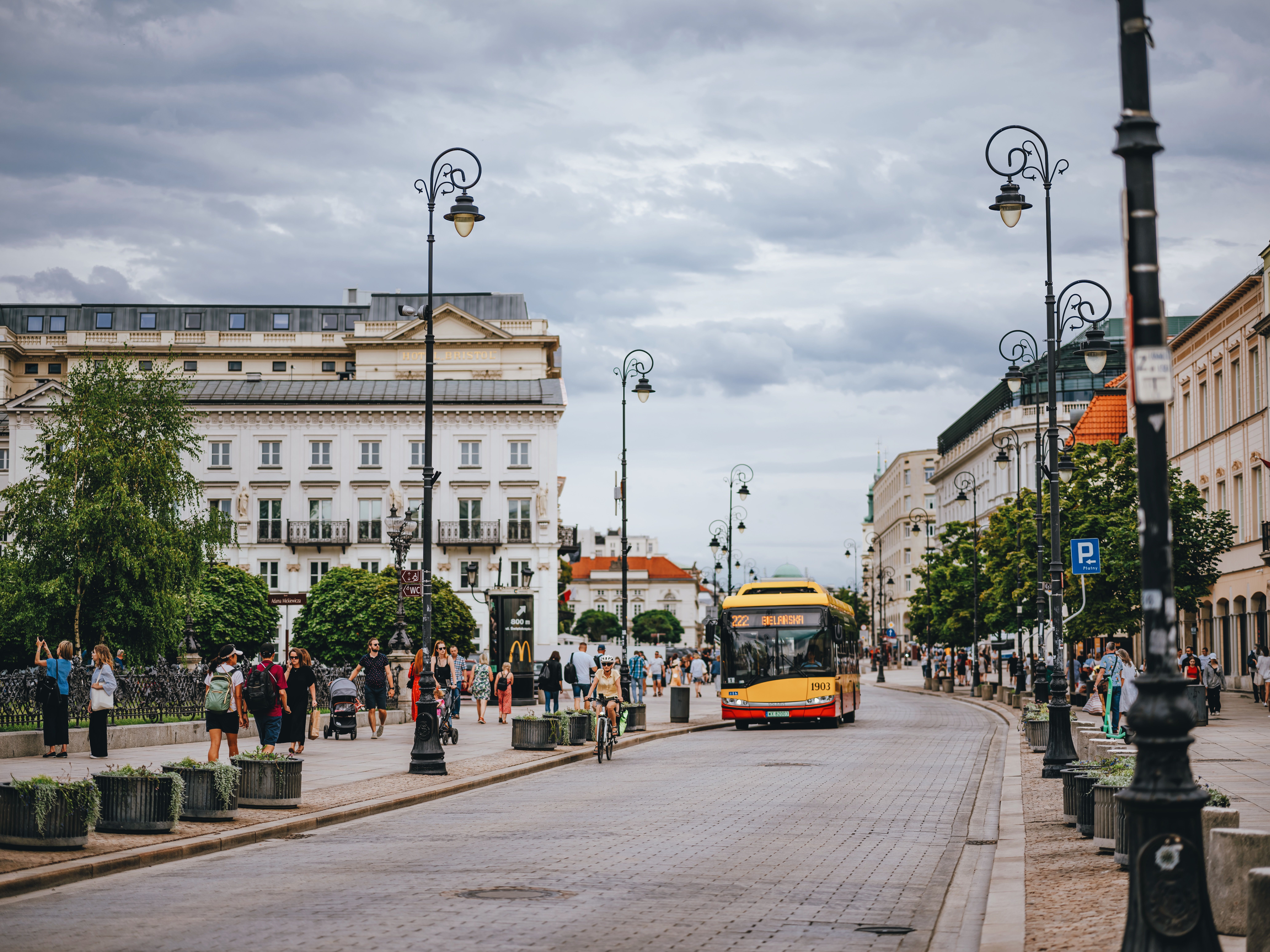 People enjoying a warm summer day in Warsaw's Old Town Square, Poland