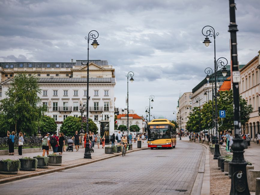 People enjoying a warm summer day in Warsaw's Old Town Square, Poland