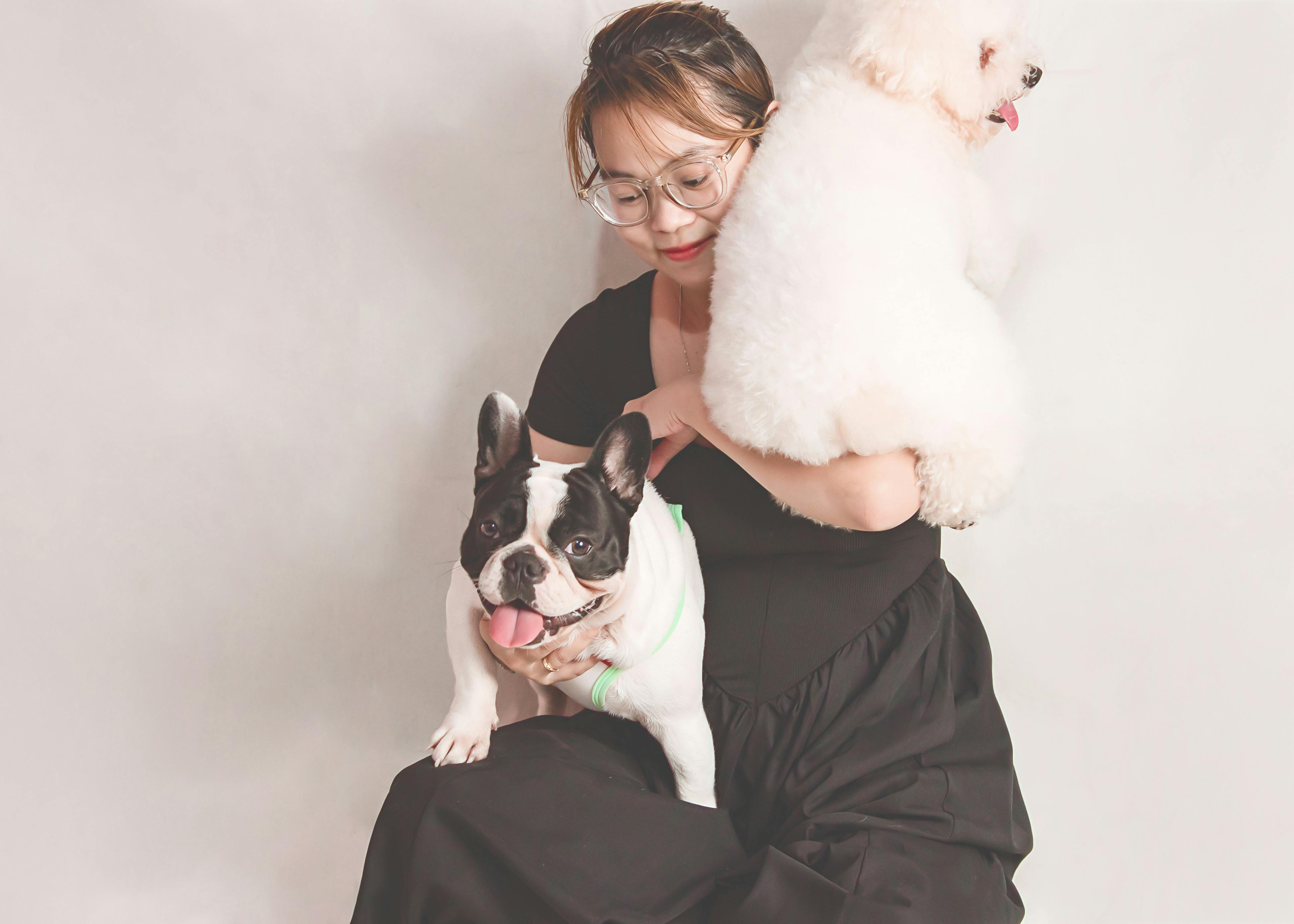 Woman in Eyeglasses Holding Two Funny Dogs