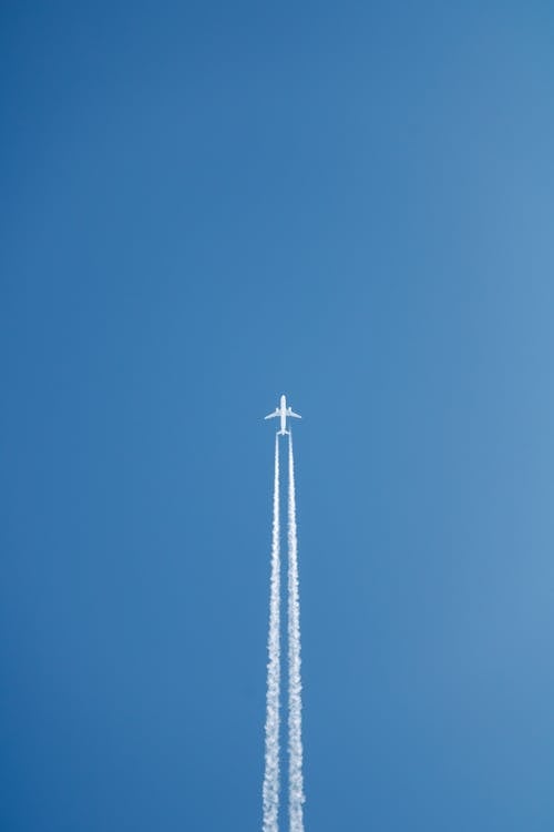 An airplane flying through the blue sky