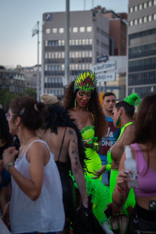 Street Performers in Green Dresses Standing among the Crowd in Barcelona