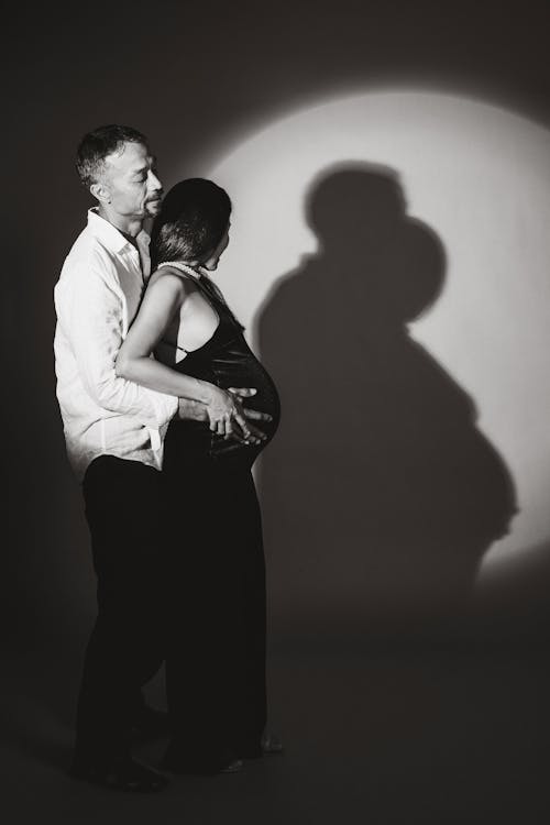 Loving Couple Posing in a Studio with a Spot Light