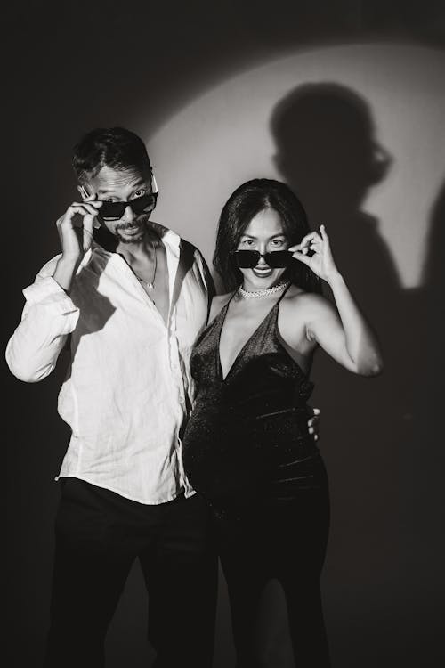 Man and Pregnant Woman Posing with Sunglasses