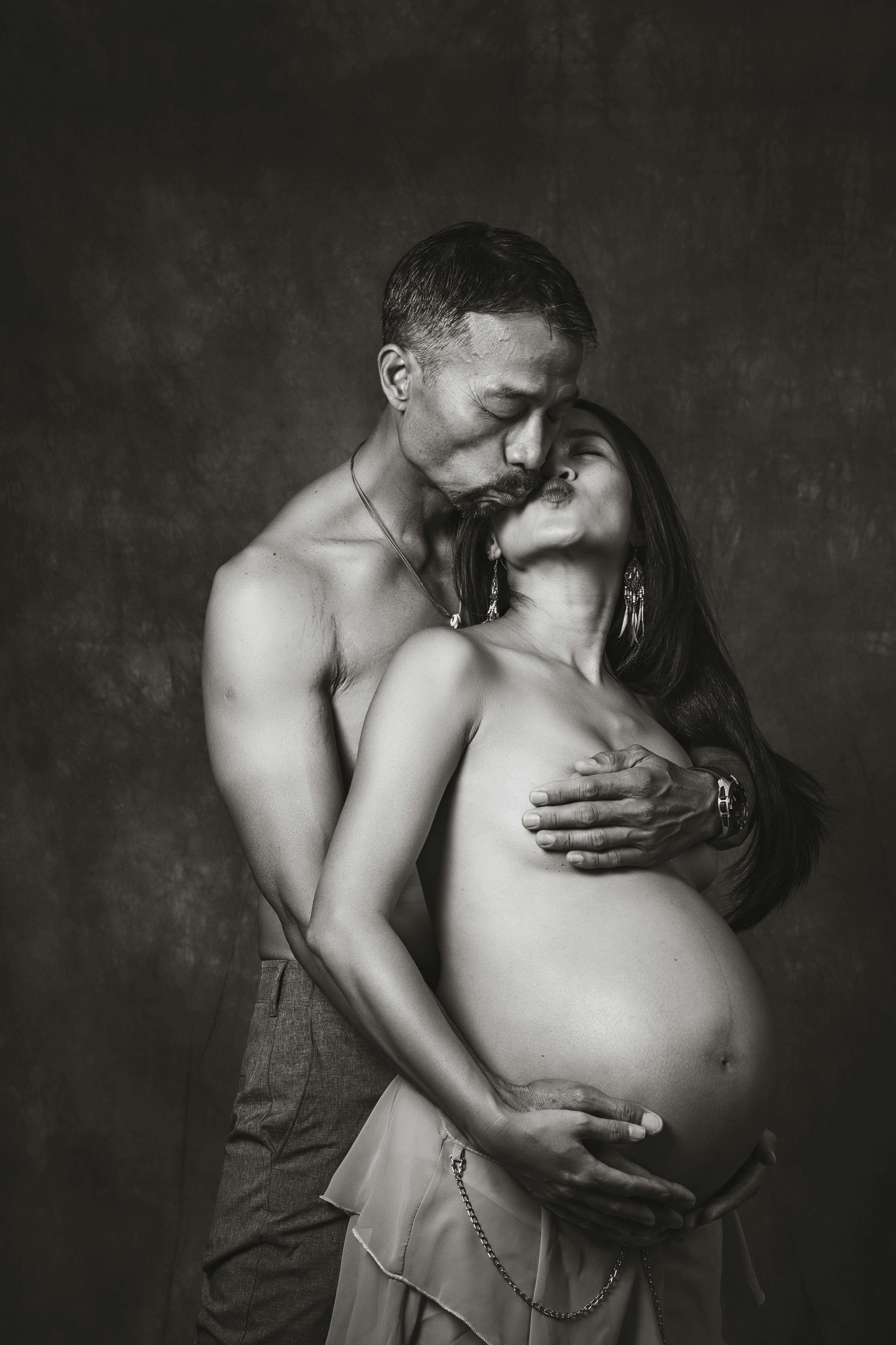 Pregnant Couple Kissing · Free Stock Photo