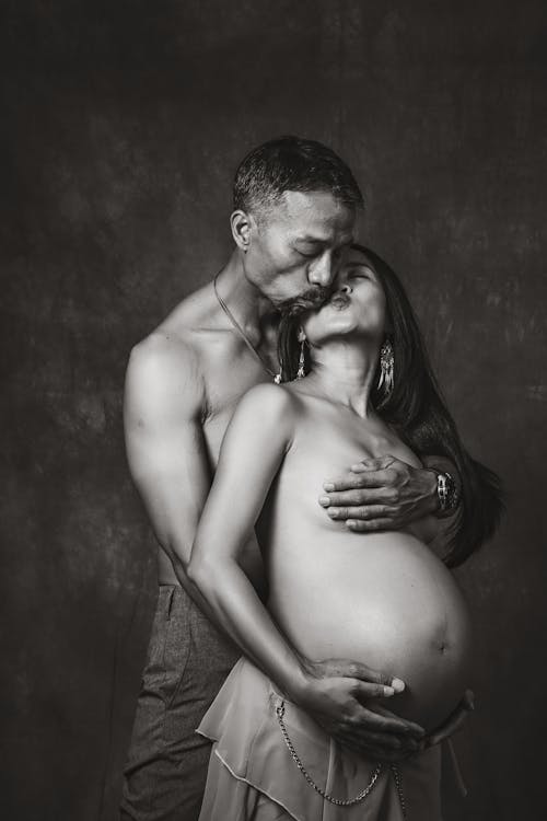 Free Pregnant Couple Kissing  Stock Photo