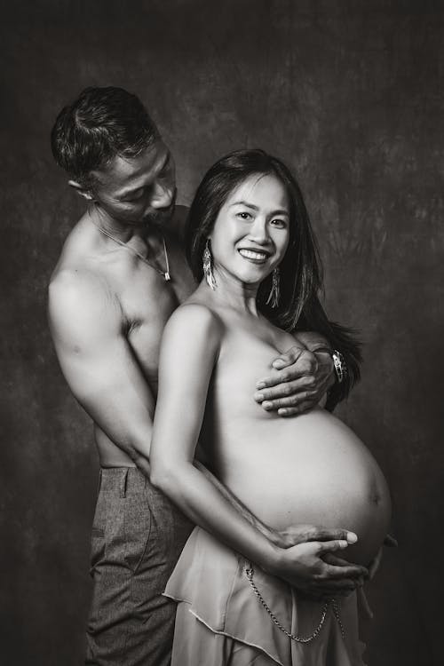 Free Man Embracing his Pregnant Partner  Stock Photo