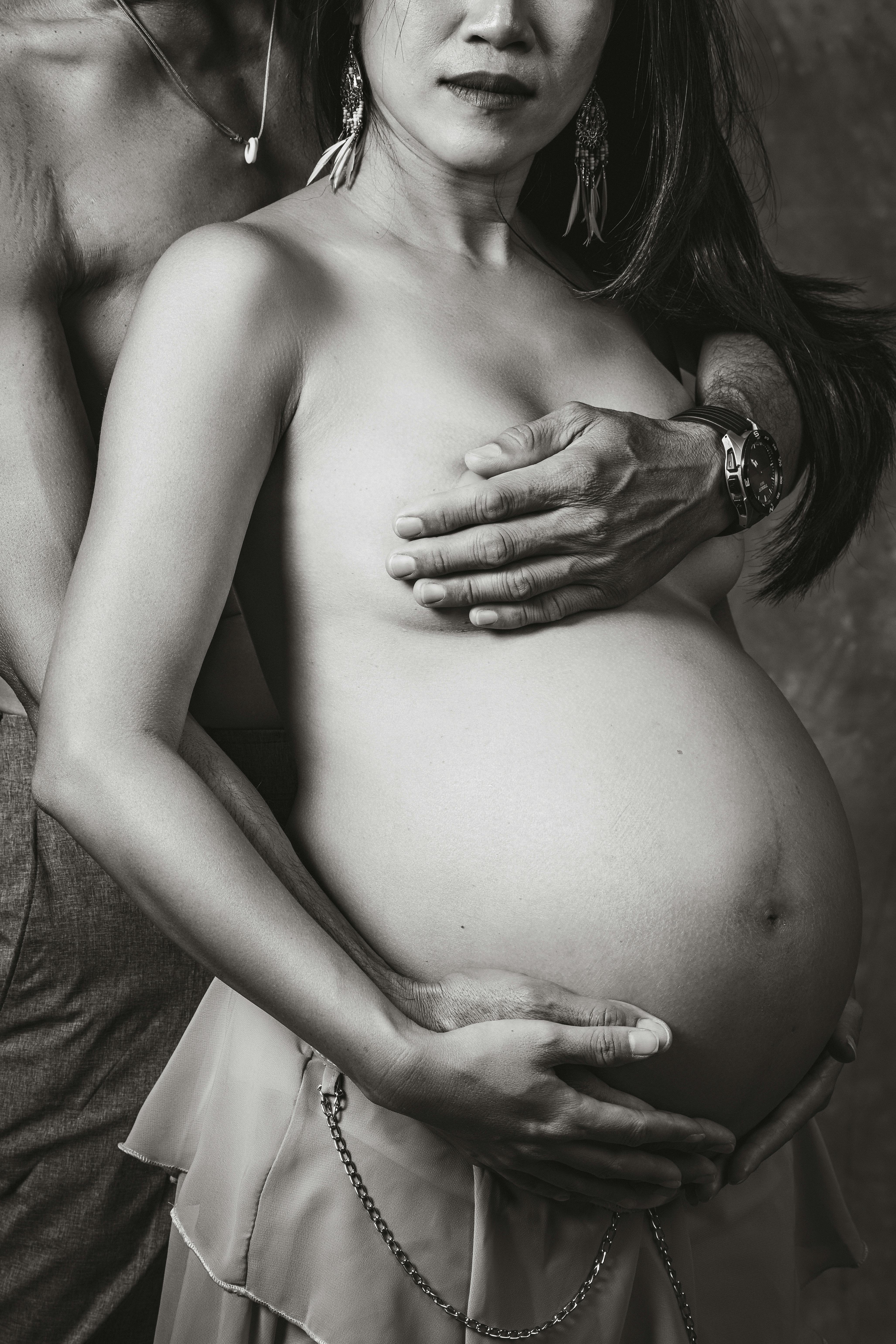 Side View Of Pregnant Woman Covering Breast While Standing Against Black  Background Photograph by Cavan Images - Fine Art America