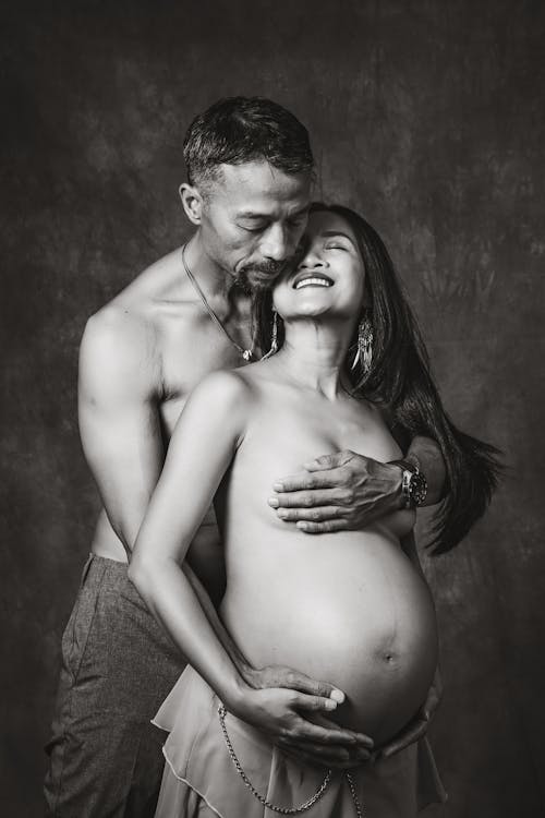 Free Portrait of a Shirtless Pregnant Couple  Stock Photo