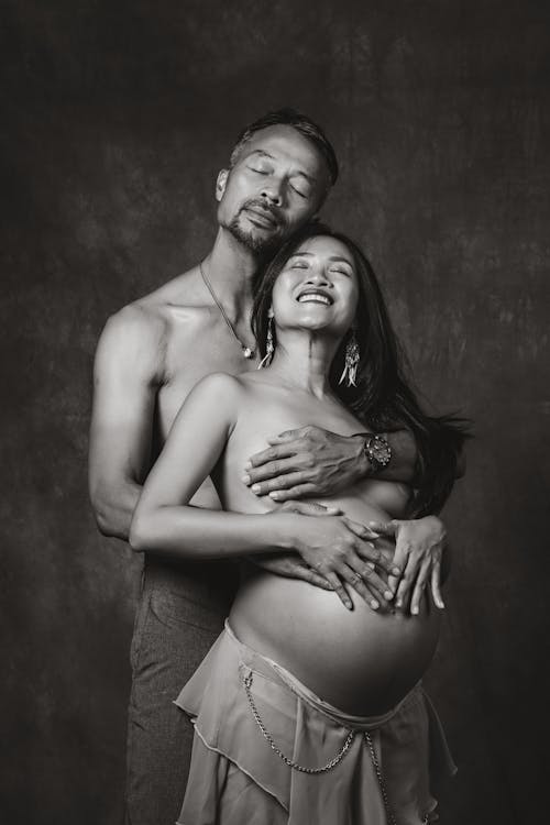 Shirtless Serene Couple with Eyes Closed in Studio