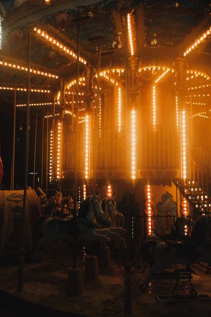 A beautifully illuminated carousel at dusk captures the magic of amusement parks.