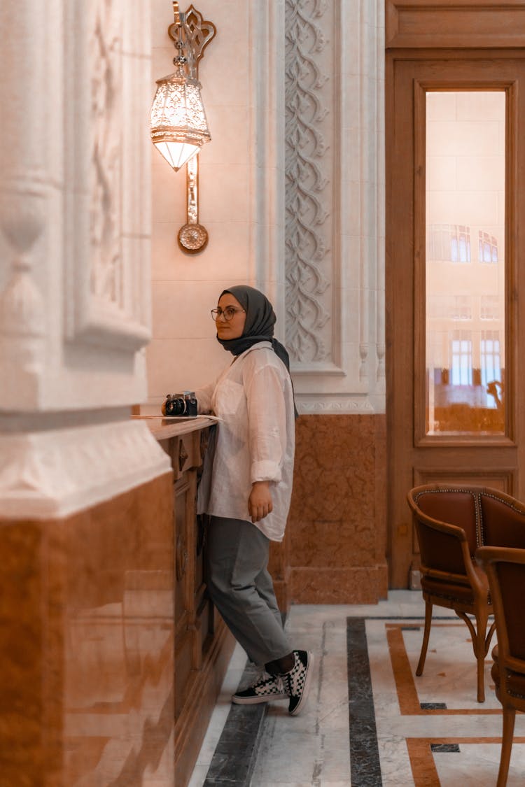 Woman Standing By The Hotel Counter 