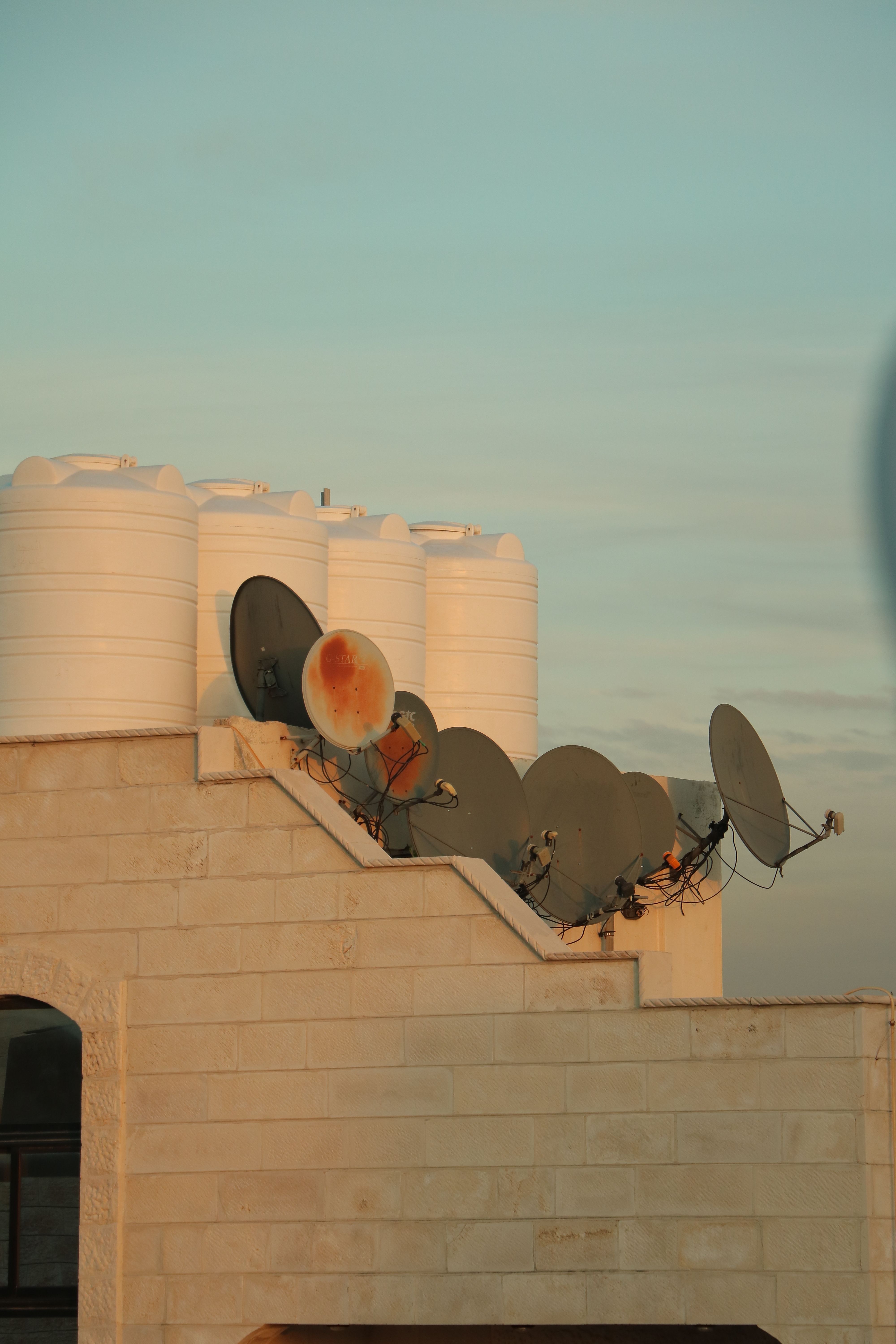 Rooftop water tank and antennas in a residential setting, the environment AquaCool is built for